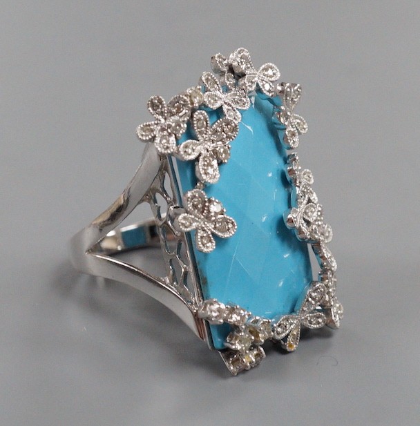 A large modern 14k white metal, turquoise and diamond chip set dress ring, the rectangular 'chequerboard' top cut turquoise weighing approx. 18.25ct, size M, gross weight 15 grams.